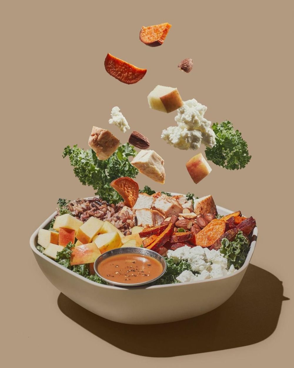 Rainbow harvest bowl with roasted carrots, avocado and greens
